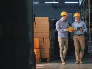 Two men walking in a warehouse