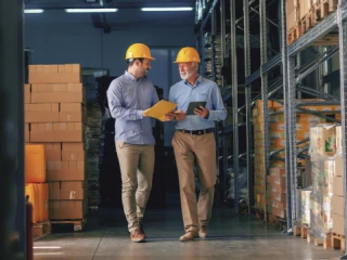 Two men walking in a warehouse